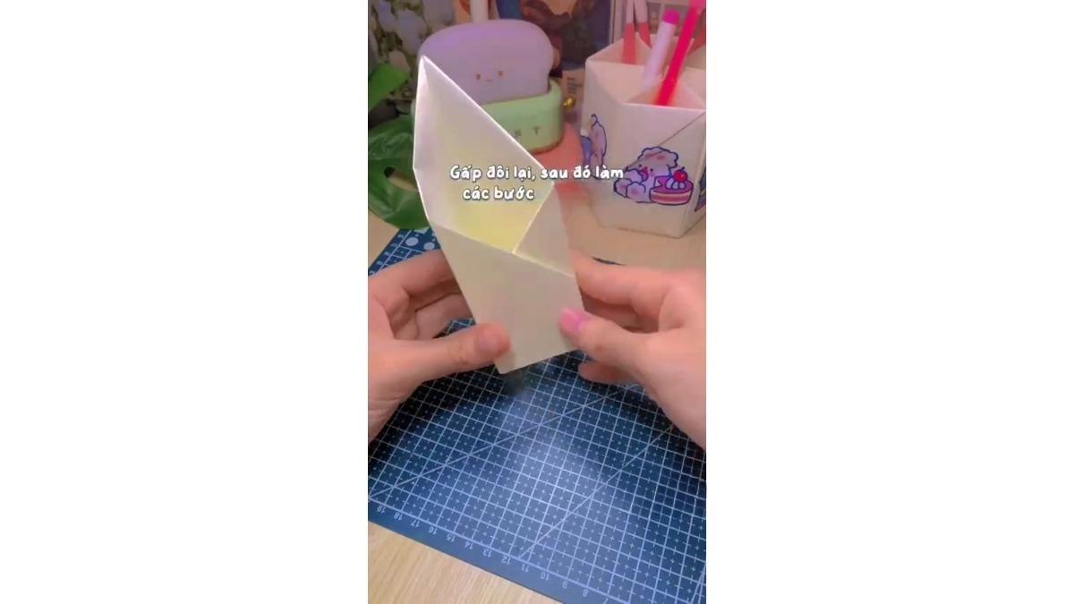 Chụm 2 nửa dưới thành hình hộp sao mép ngoài nửa này chạm vào nếp gập nửa kia